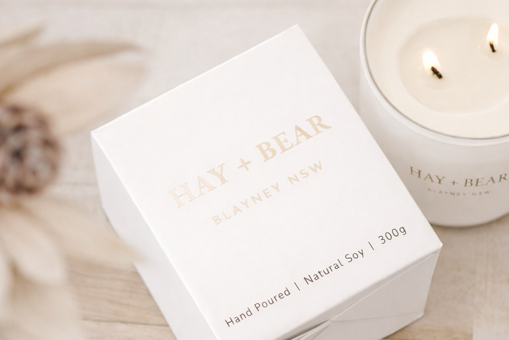 Candle packaging with 'HAY & BEAR' branding on a neutral background